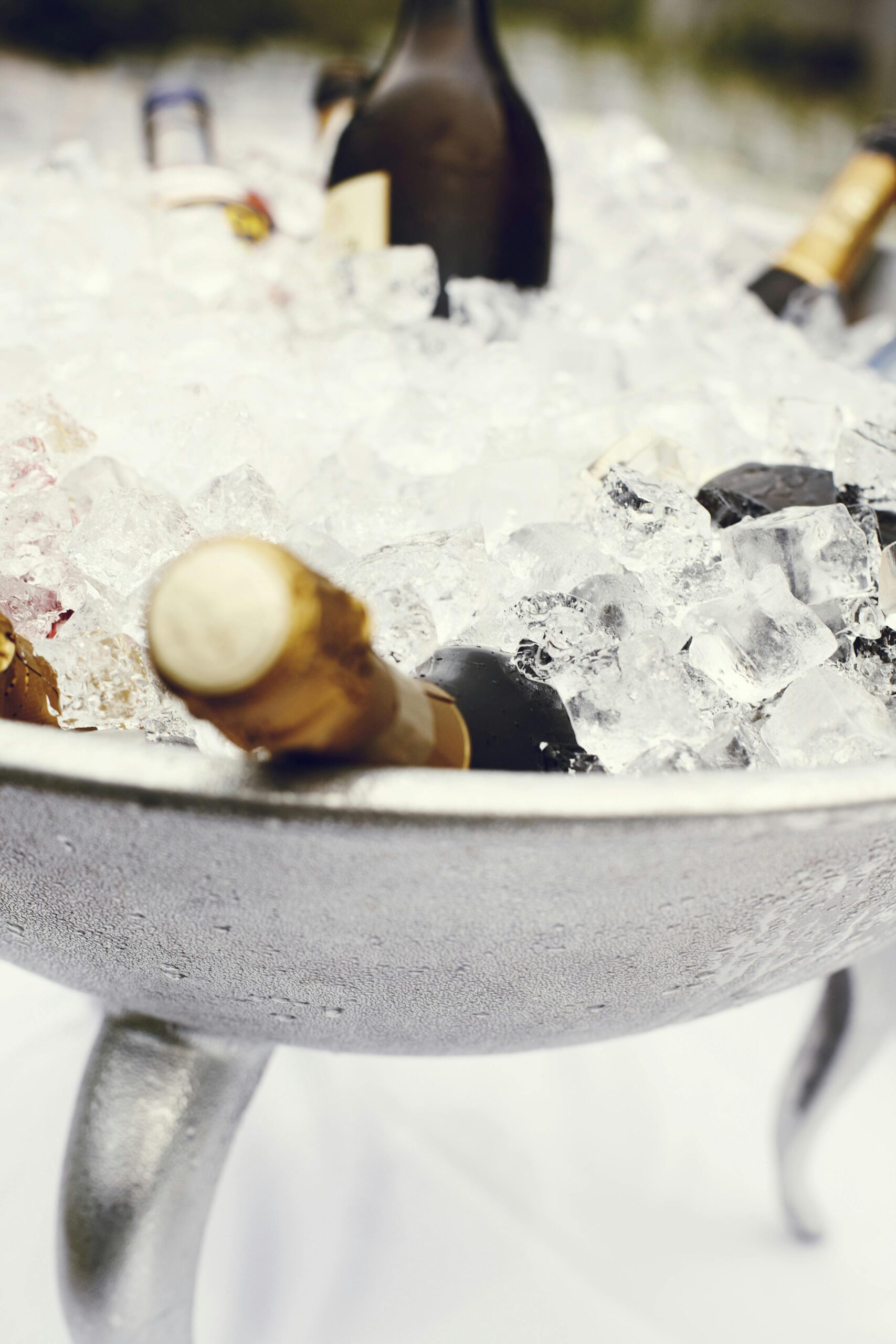 Close-up of chilled champagne bottles in an ice bucket, perfect for celebrations and parties.